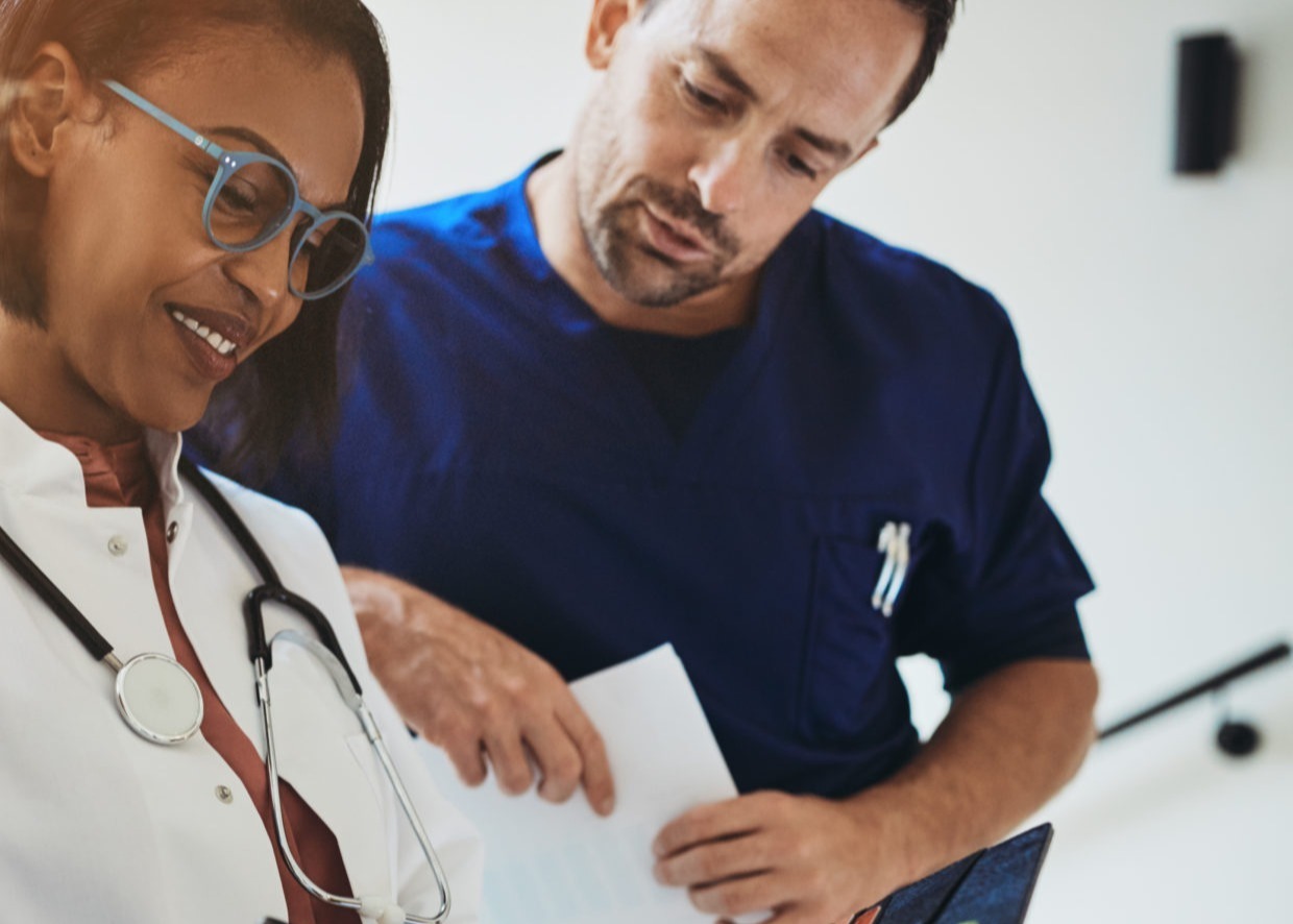 smiling-doctor-talking-with-interns-in-a-hospital-1