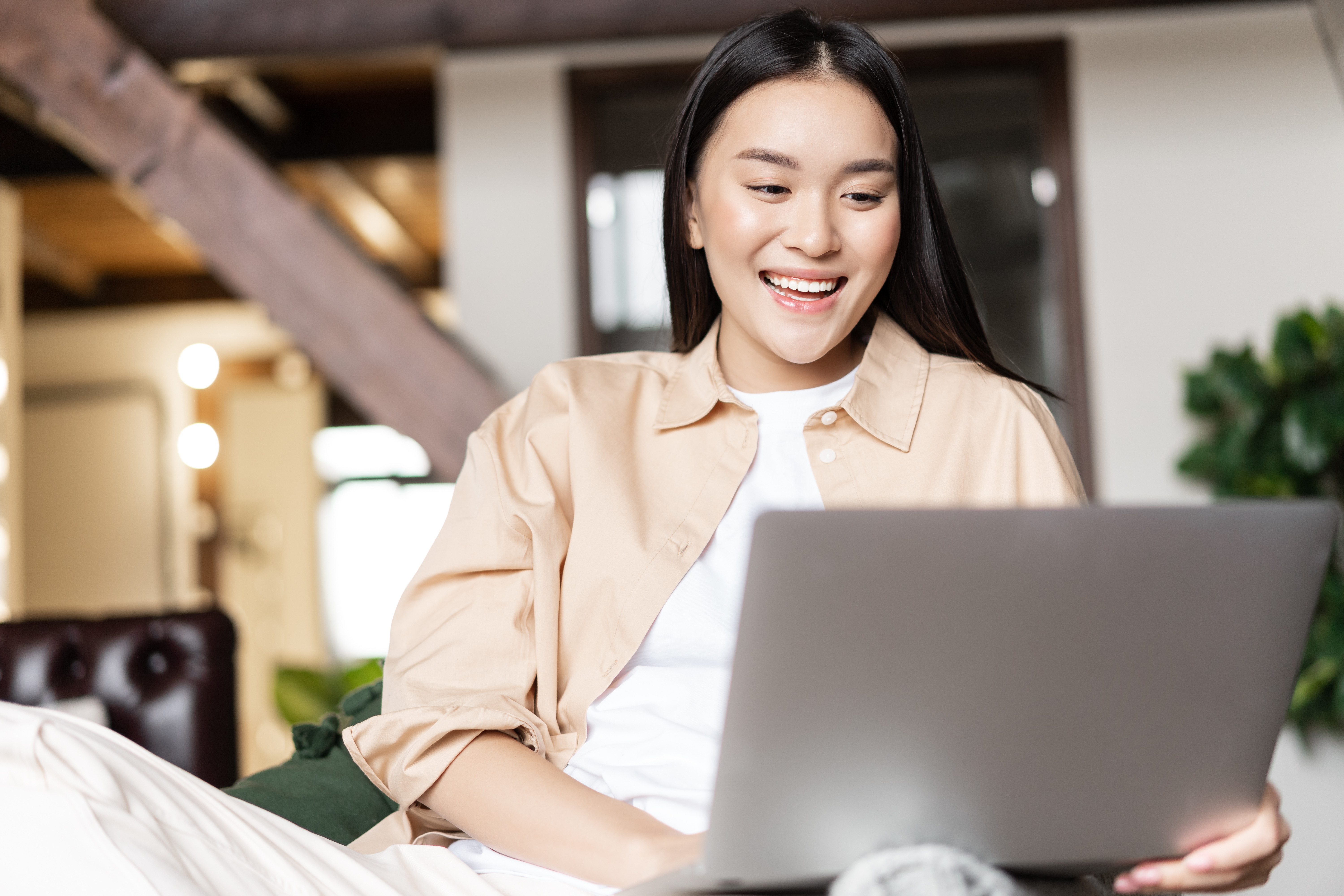 happy-asian-woman-resting-at-home-with-laptop-wat-2022-08-14-04-58-22-utc